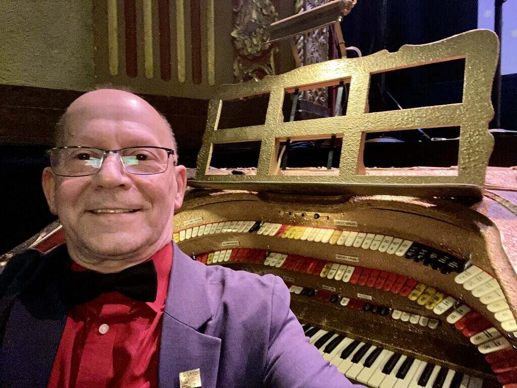 Photo of Dr. William Coale by the Barton Organ in the Michigan Theater