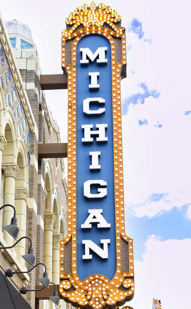 Early evening photo of the Michigan Theater sign with its lights on