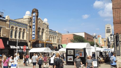Outdoor photo of the Michigan and State Theaters, long shot off Liberty St during the Ann Arbor Art fair in 2023
