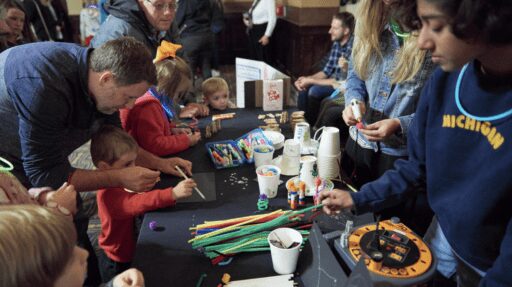 Photo of children, youths, and adults doing crafts in the Michigan Theater lobby