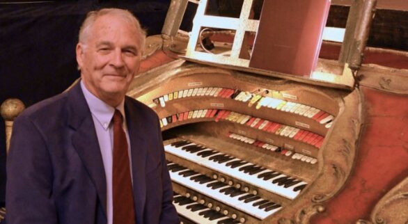 Photo of organist Henry Aldridge in front of the Barton Organ in the Michigan Theater