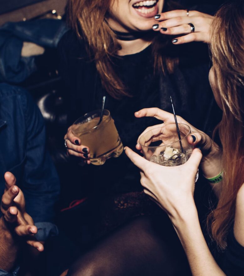 Close up image of women enjoying a drink at an event